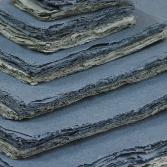 Grey shades of Khadi paper in various sizes.